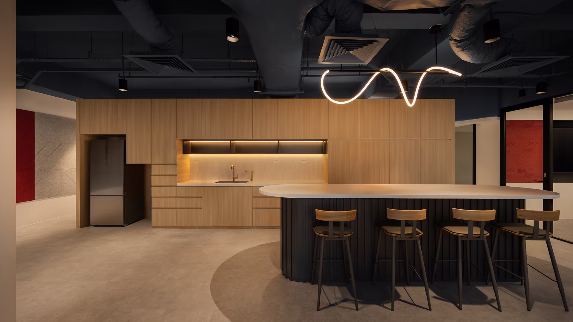 A shared pantry can support everyday use while also creating space for informal conversations and casual meetings.